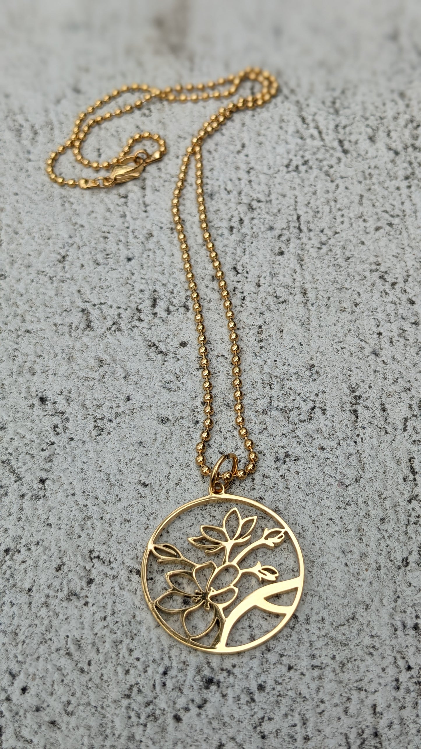 Stainless steel blossom charm necklace gold plated