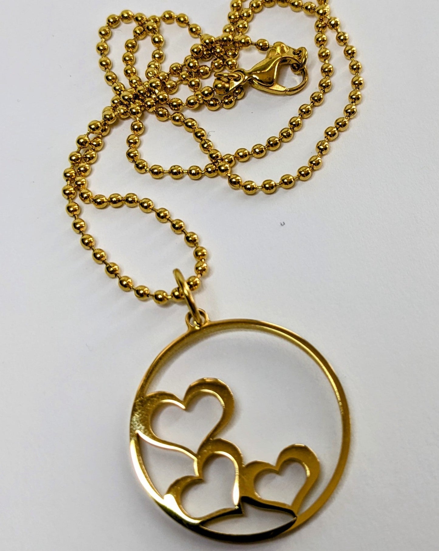 Stainless steel stacked hearts charm necklace gold